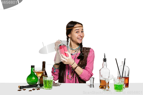 Image of Expert female barman is making cocktail at studio