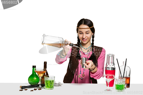 Image of Expert female barman is making cocktail at studio