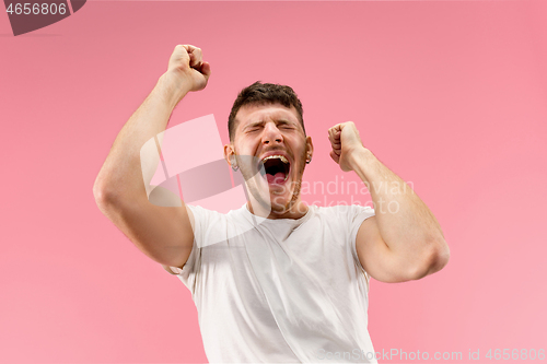 Image of Winning success man happy ecstatic celebrating being a winner. Dynamic energetic image of male model