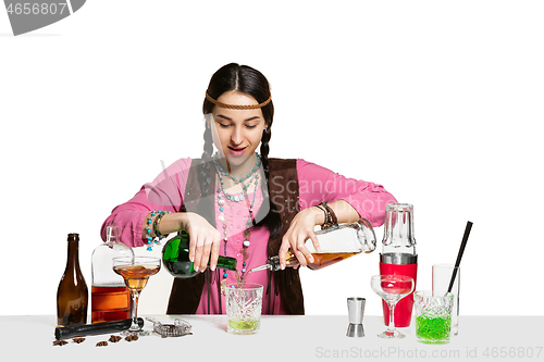 Image of Expert female barman is making cocktail at studio