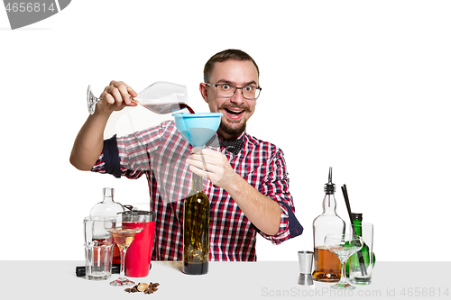 Image of Expert barman is making cocktail at studio