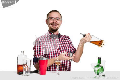 Image of Expert barman is making cocktail at studio