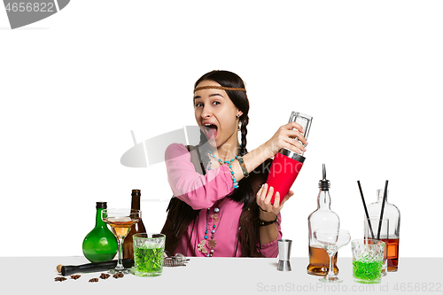 Image of Expert female barman is making cocktail at studio