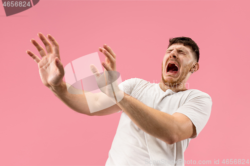 Image of Portrait of the scared man on pink