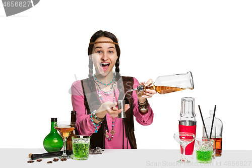 Image of Expert female barman is making cocktail at studio