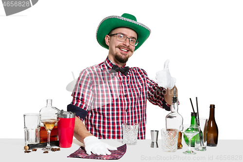 Image of Expert barman is making cocktail at studio