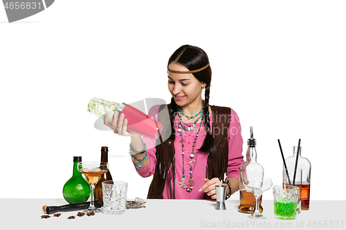 Image of Expert female barman is making cocktail at studio