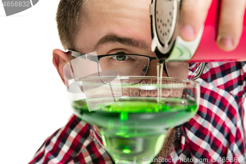 Image of Expert barman is making cocktail at studio