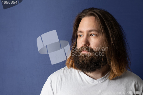 Image of bearded young man with long hair