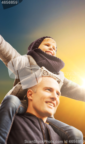 Image of happy family having fun in autumn park