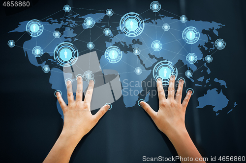 Image of hands using interactive panel with network icons