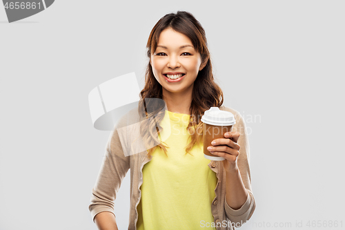 Image of happy asian woman drinking coffee