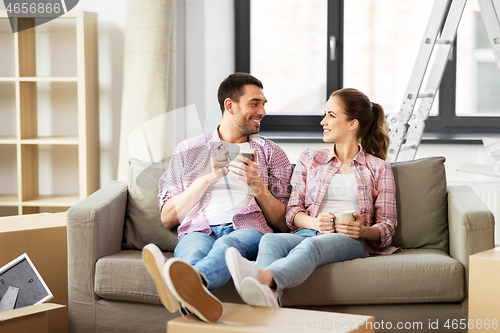 Image of happy couple drinking coffee moving to new home