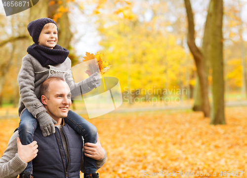 Image of happy family having fun in autumn park