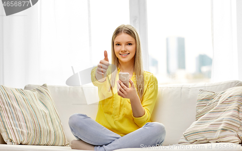 Image of young woman or teen girl with smartphone at home