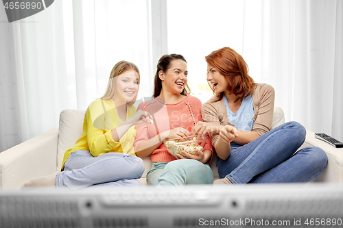 Image of teenage girls or friends watching tv at home