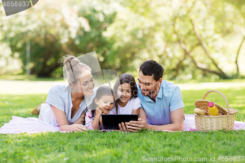 Image of family with tablet pc on picnic in summer park