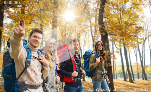 Image of friends with backpacks hiking in autumn