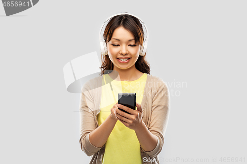 Image of asian woman in headphones listening to music