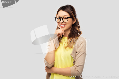 Image of happy asian woman in glasses or student