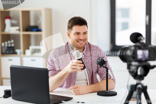 Image of male blogger with microphone videoblogging