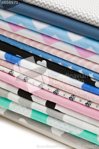 Image of Stack of cotton fabric material isolated on white