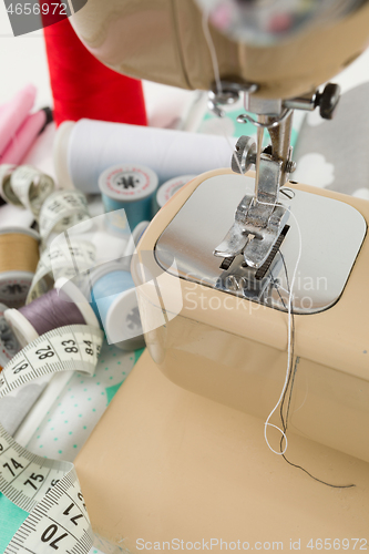Image of Sewing machine, fabric and measurement tape