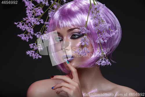 Image of Beautiful girl in purple wig with flowers