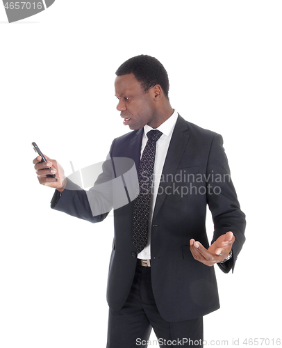 Image of African man looking at his cell phone
