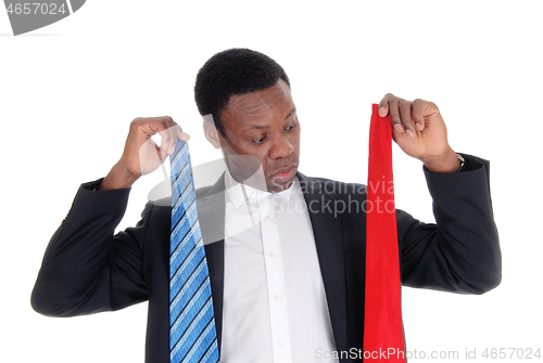 Image of Man can not decide what necktie to wear