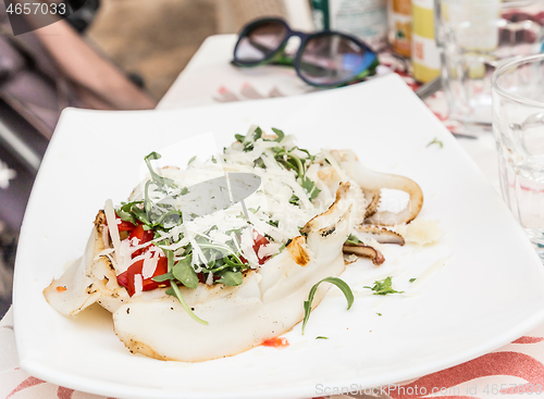 Image of Cuttlefish with tomato, salad and Parmigiano cheese