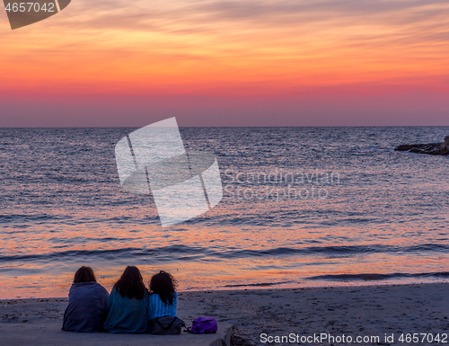 Image of Three friends looking to the sunrise