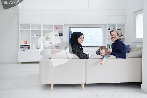 Image of Happy Muslim family having fun at home