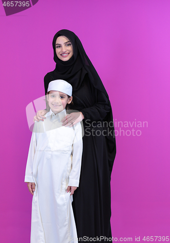 Image of portrait of muslim mother and son on pink background