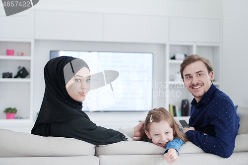 Image of Happy Muslim family having fun at home