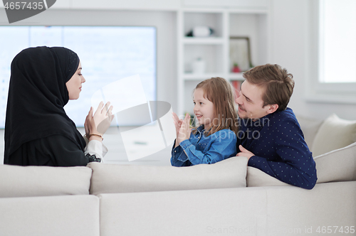 Image of Happy Muslim family having fun at home