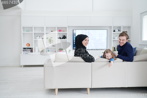 Image of Happy Muslim family having fun at home