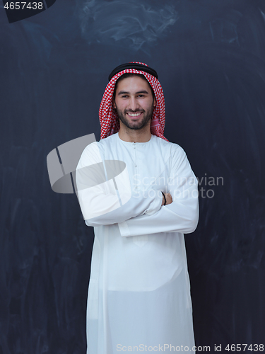 Image of portrait of arabian man in front of black chalkboard