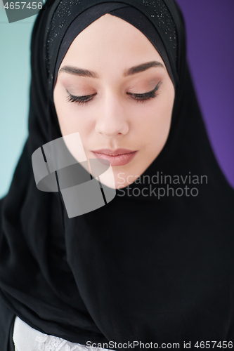 Image of young modern muslim business woman using smartphone at home