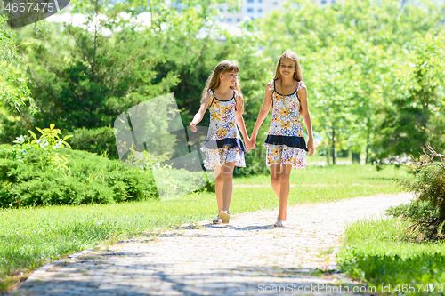 Image of girls walk in the park and chat with each other