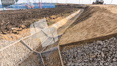 Image of Strengthening the slope and constructing a drainage ditch along the road