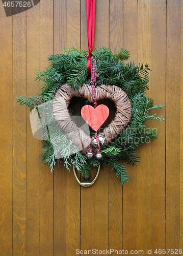 Image of Traditional christmas wreath on a wooden door