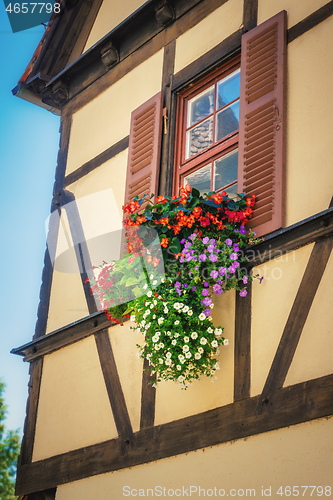 Image of flowers at a half-timbered house window