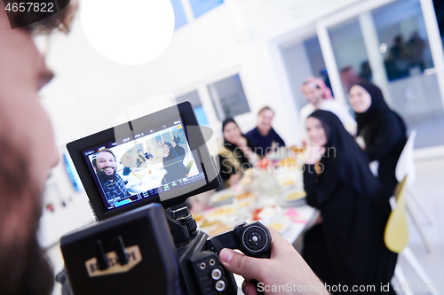 Image of professional videographer recording Ramadan feast