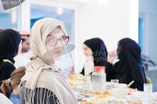 Image of young muslim woman having Iftar dinner with family