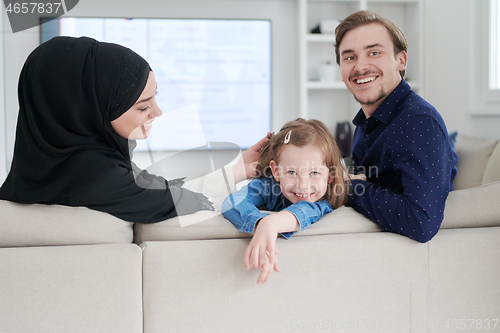 Image of Happy Muslim family having fun at home