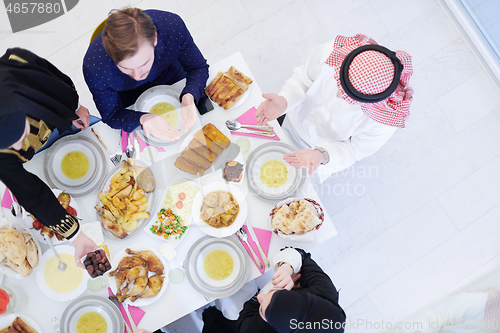 Image of traditional muslim family praying before iftar dinner top view