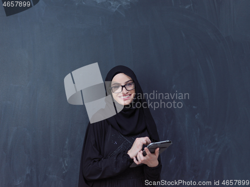 Image of young muslim business woman using tablet computer