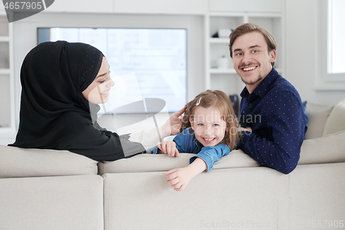 Image of Happy Muslim family having fun at home