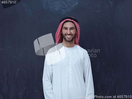 Image of portrait of arabian man in front of black chalkboard